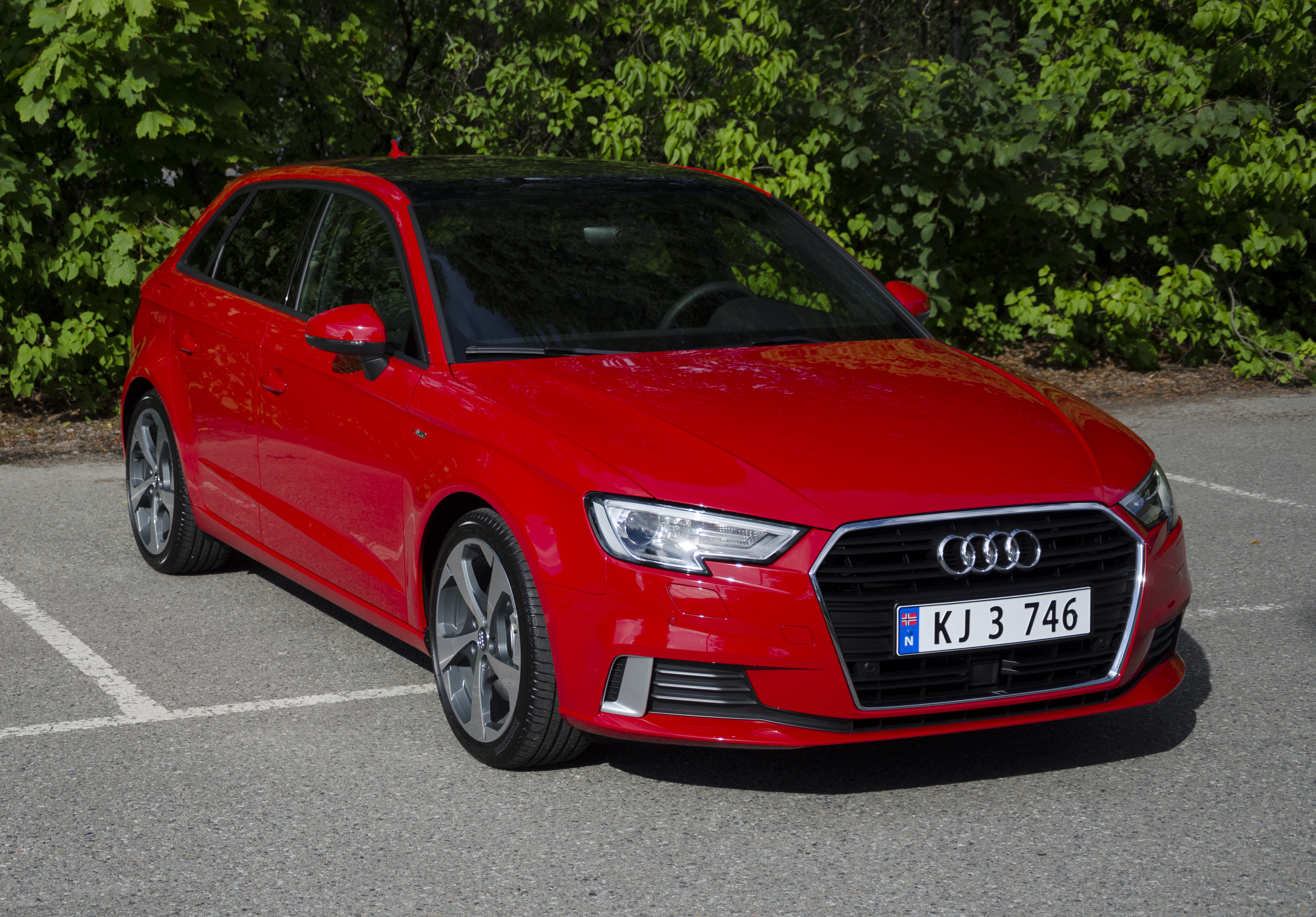 new red Audi hatchback front view